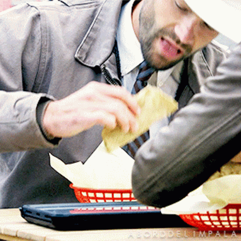 Man Sitting at Table with Food Basket
