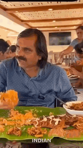 Man Sitting at Table with Food