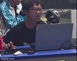 Man Sitting at Table With Laptop and Headphones