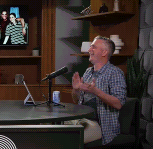 Man Sitting at Table with Microphone and Yes