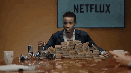 Man Sitting at Table with Money