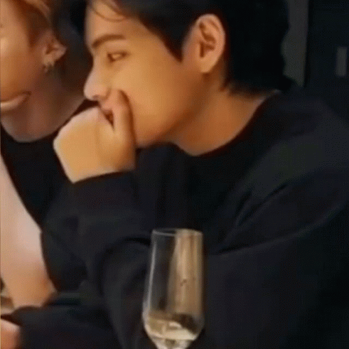 Man Sitting at Table with Wine and Cell Phone