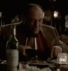 Man Sitting At Table With Wine Bottle GIF