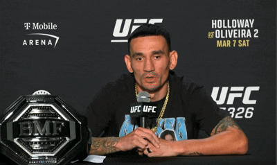 Man Sitting At UFC Sign GIF