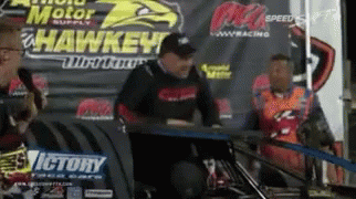 Man Sitting at Victory Sign