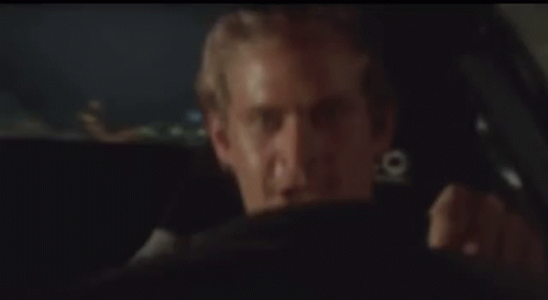 Man Sitting in Back Seat of Car at Night