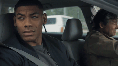 Man Sitting In Back Seat While Another Man Drives GIF