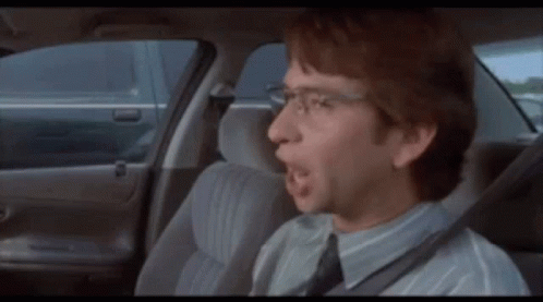 Man Sitting in Back Seat with Open Mouth