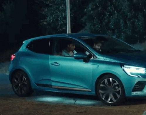 Man Sitting in Blue Car With Open Door