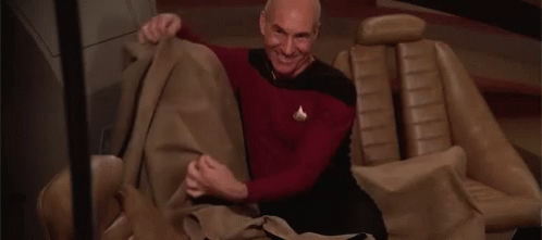 Man Sitting In Car Holding Blanket GIF