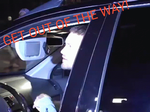 Man Sitting in Car Saying Get Out of the Way