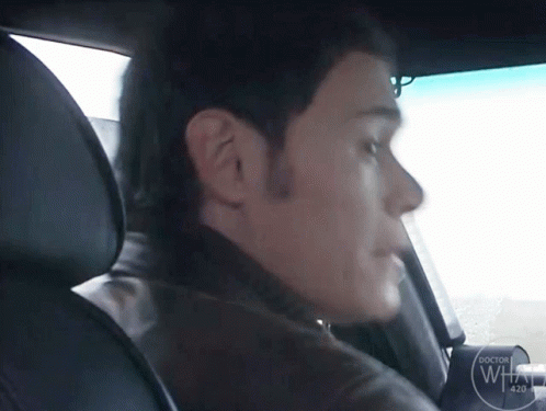Man Sitting in Car with Doctor Logo