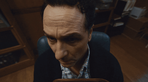 Man Sitting In Chair Looking GIF