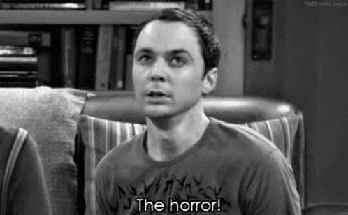 Man Sitting In Chair Saying The Horror GIF