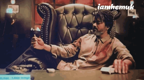 Man Sitting in Chair Smoking Cigarette