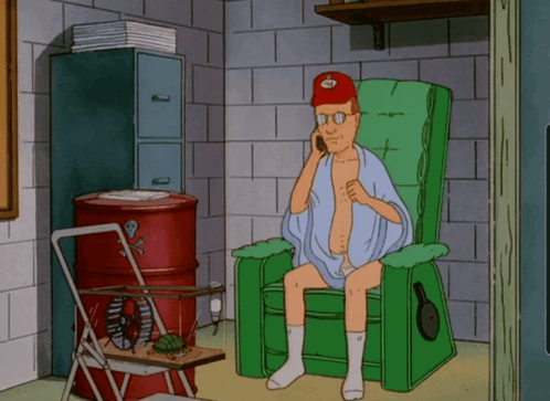 Man Sitting in Chair Talking on Cell Phone