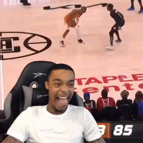 Man Sitting in Chair Watching Basketball Game With Number 85