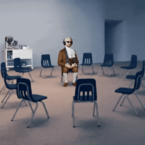 Man Sitting In Chair With Blue Chairs GIF