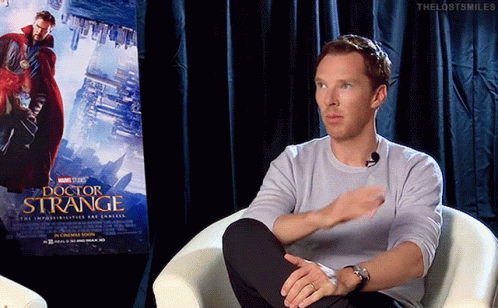 Man Sitting in Chair with Doctor Strange Poster