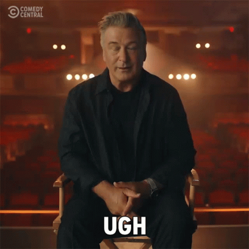 Man Sitting in Chair With Hand on Face Comedy Central Logo