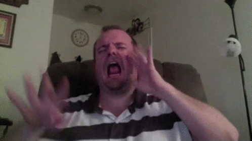 Man Sitting in Chair with Mouth Open