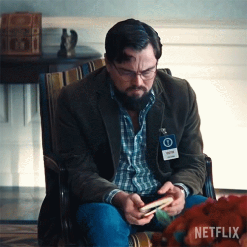 Man Sitting in Chair with Netflix Name Tag