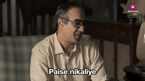 Man Sitting In Chair With Paise Nikalye GIF