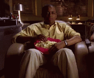 Man Sitting in Chair With Popcorn