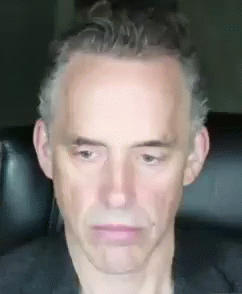 Man Sitting In Chair With Serious Look GIF