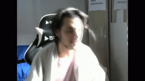 Man Sitting In Chair With Sign Das Pessoas GIF