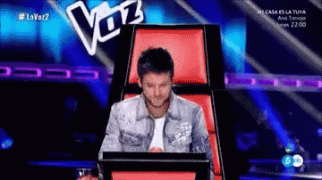 Man Sitting in Chair with Voz Sign