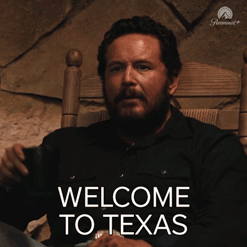 Man Sitting In Chair With Welcome To Texas On Screen