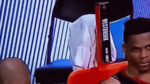 Man Sitting In Chair With Westbrook Sign GIF