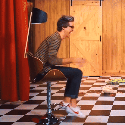 Man Sitting in Checkerboard Floor