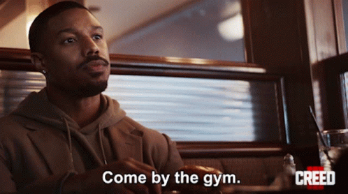 Man Sitting in Diner with Come By the Gym