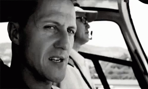 Man Sitting in Driver's Seat Looking Out Window