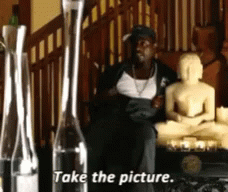 Man Sitting in Front of Buddha Statue Take the Picture