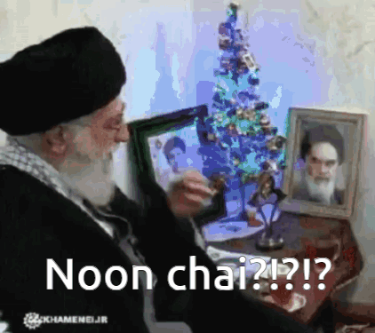 Man Sitting in Front of Christmas Tree Noon Chai