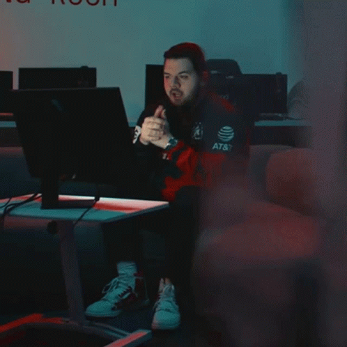 Man Sitting in Front of Computer With Rokit Shirt