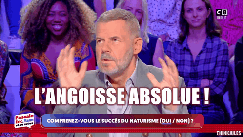 Man Sitting in Front of Crowd with L'angoisse Absolue