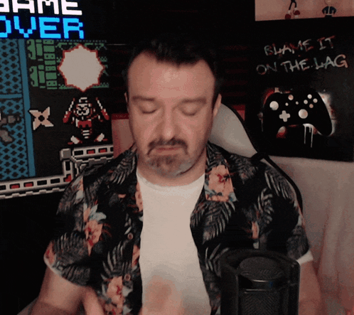 Man Sitting in Front of Game Over Sign