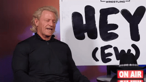 Man Sitting In Front Of Hey Ew Sign GIF