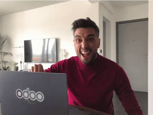 Man Sitting in Front of Laptop Saying Odoo