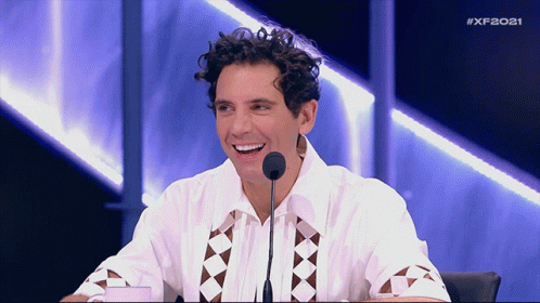 Man Sitting in Front of Microphone