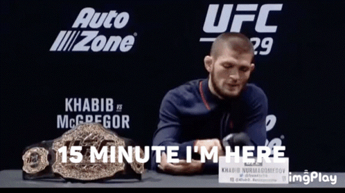 Man Sitting In Front Of UFC Sign GIF