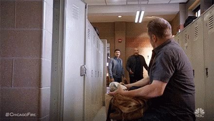 Man Sitting In Locker Room Holding Fur Coat GIF