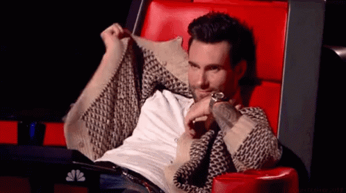 Man Sitting in Red Chair with Outstretched Arms