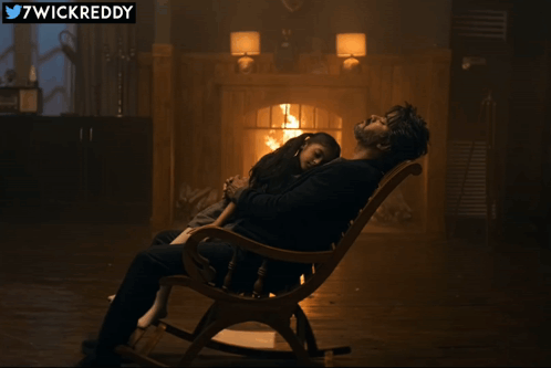Man Sitting in Rocking Chair with Little Girl