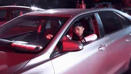 Man Sitting In Silver Car With M On Side GIF