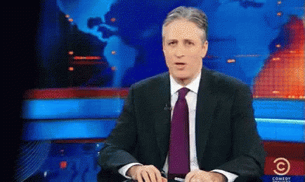 Man Sitting In Suit And Tie At Comedy Central Screen GIF
